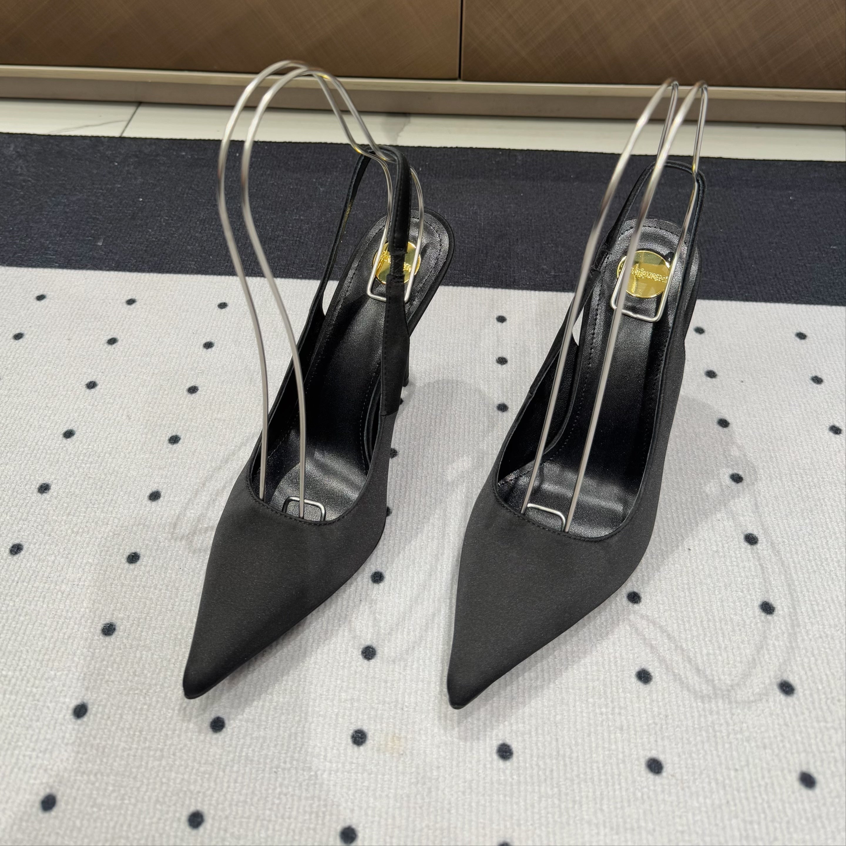 L'ENTRACTE SLINGBACK PUMPS IN BLACK SATIN