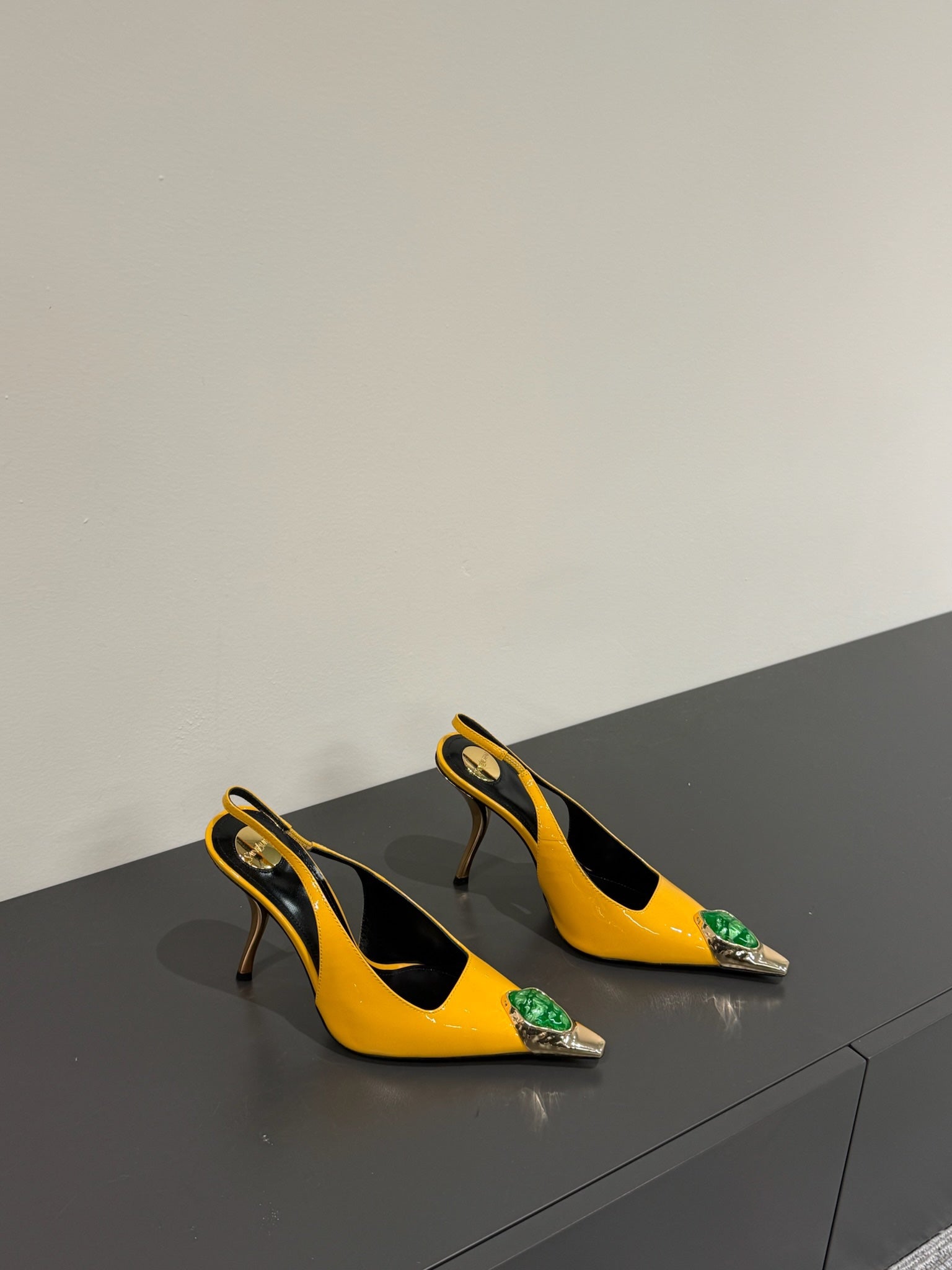 GREEN GEM-STUDDED SLINGBACK PUMPS IN YELLOW PATENT CALFSKIN